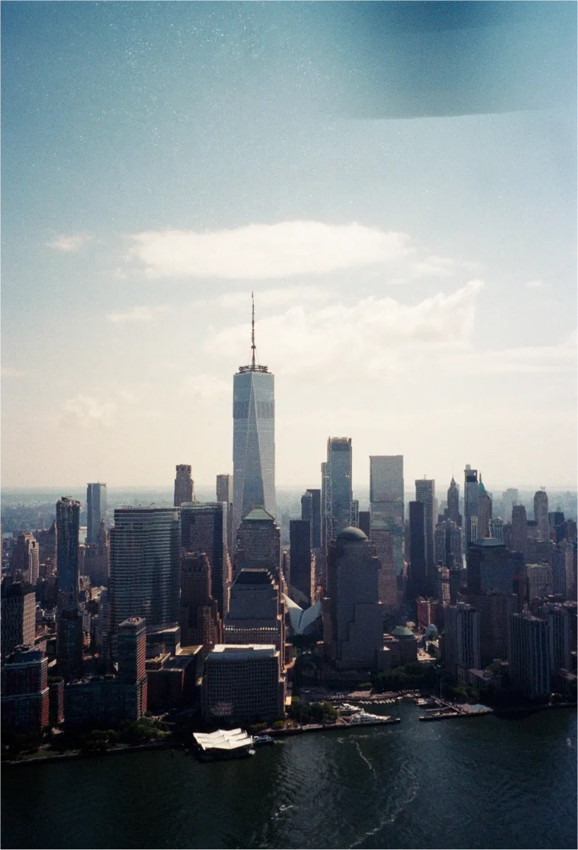 Aerial view of Lower Manhattan with One World Trade Center rising above the skyline.
